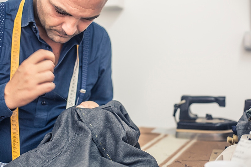 Antonio Ambrosi hand-stiches a pair of trousers