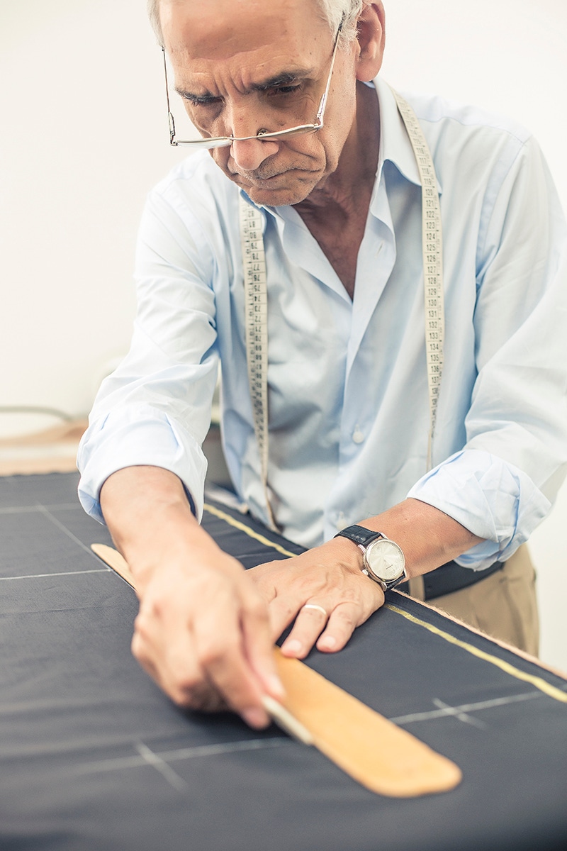 Antonio Ambrosi checks the pattern of a pair of trousers.