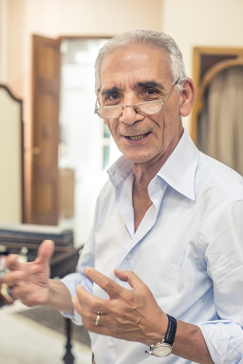 Antonio Ambrosi checks the pattern of a pair of trousers.