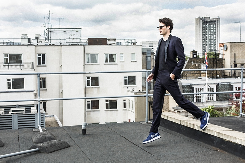 Midnight-blue silk shawl lapel spotted evening suit, Richard James; black and white spot V-neck T-shirt, Kilgour; clear grey acetate sunglasses, Oliver Goldsmith; Navy suede Air Force 1 07 sneakers, Nike.