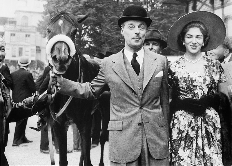 The Baron Guy de ROTHSCHILD and his young wife Marie Helene leading their mare CERISOLES to the paddock after it won the Prix de Diane in Chantilly on June 10, 1957.