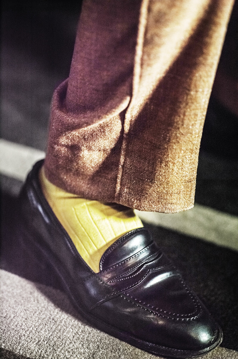 The use of lapped seams is unusual, and the fact you don't see them much is the reason he decided it was a good idea. The shoes are cordovan shell loafers from Alden in New York. Fine shoes are vital for a job on one's feet such as his.