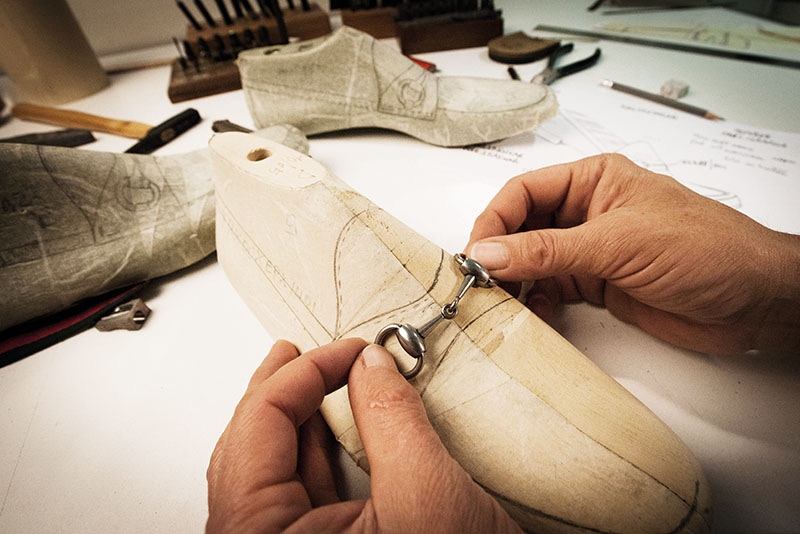 Designing a paper horsebit loafer pattern.