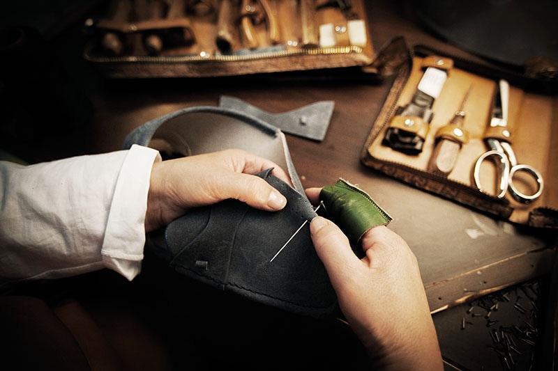 Hand-stitching the uppers.