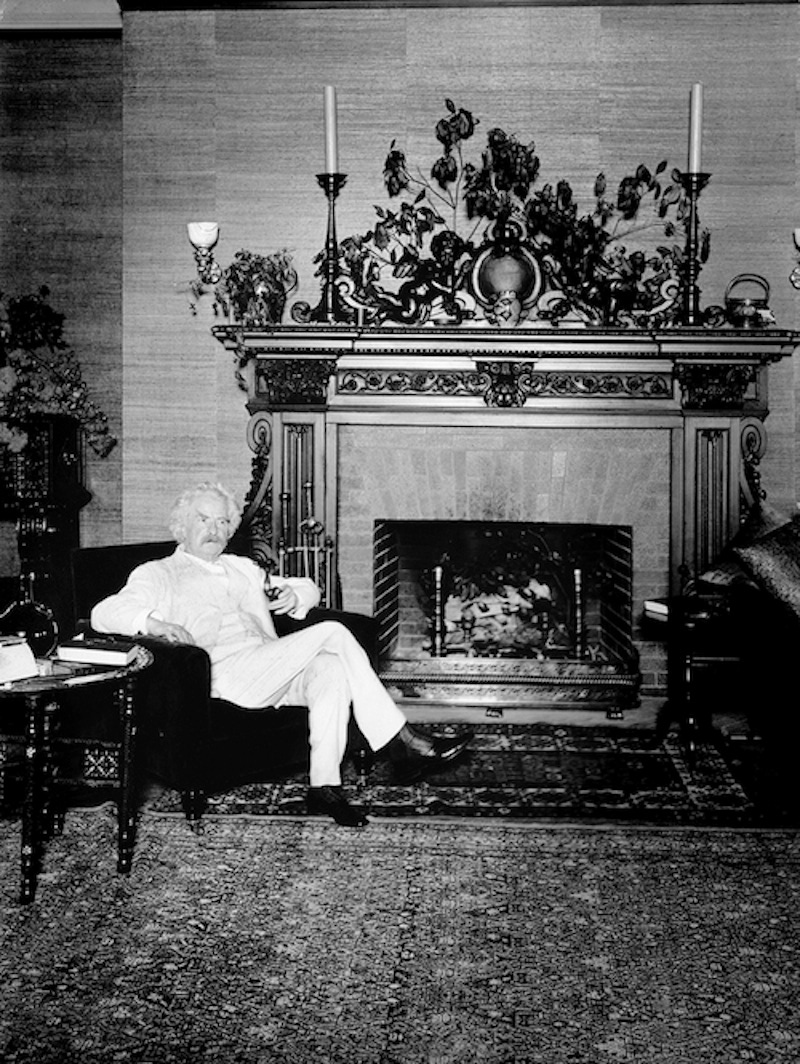 American author and humorist Samuel Langhorne Clemens - better known as Mark Twain - enjoying a tipple in his library (1909).