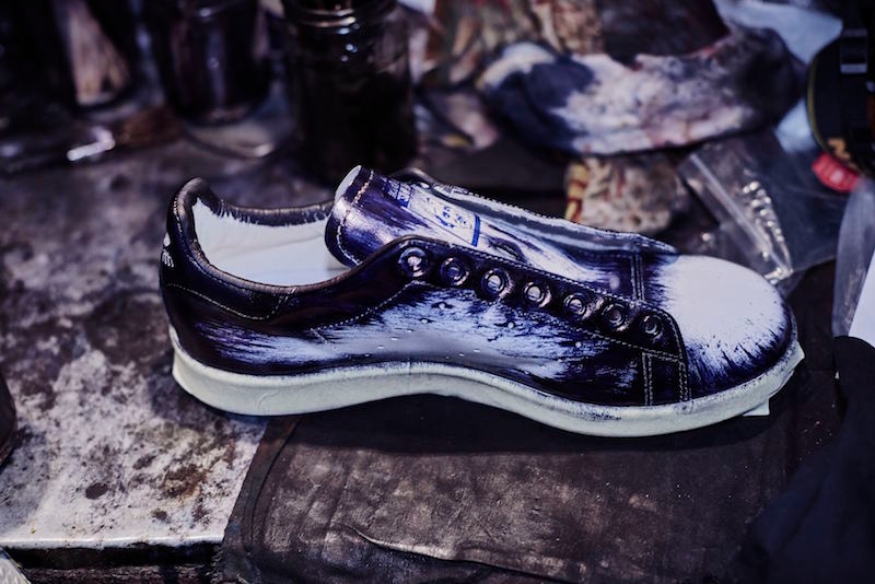 Lighter brush strokes cover the centre of the sneaker, building up the patina layer by layer.