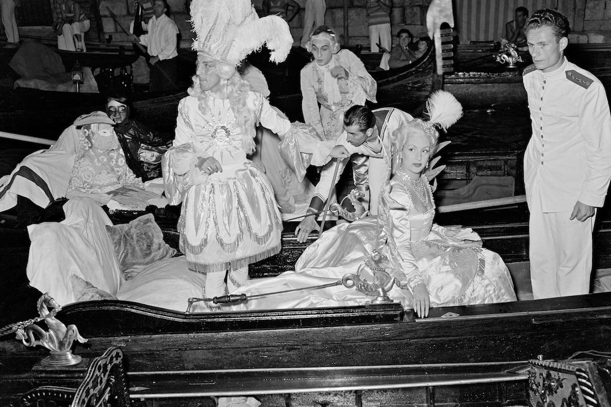 Jacques Fath and his wife arrive via gondola (Photo via Getty)