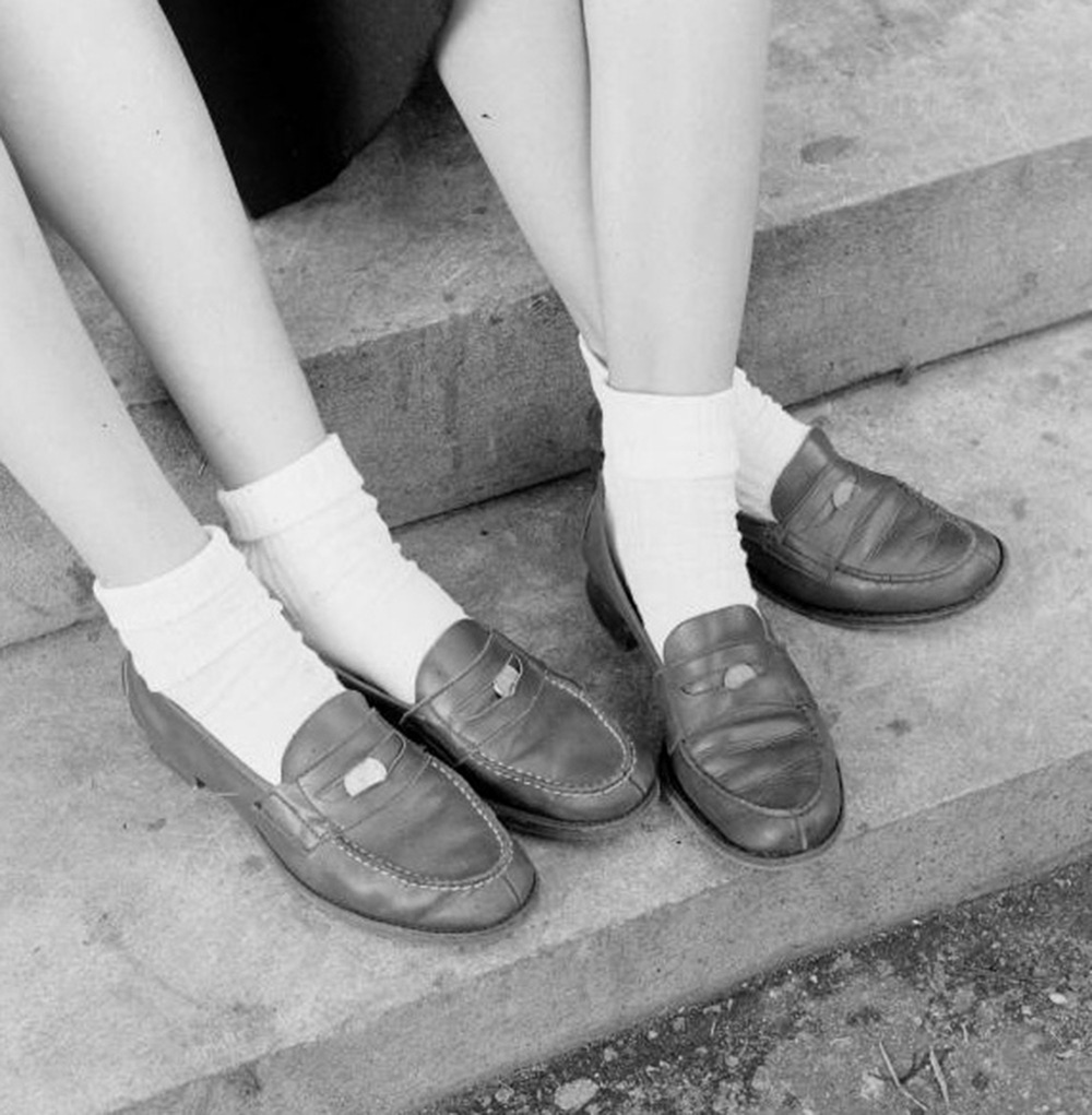 Girls with pennies in their shoes, circa 1950s.