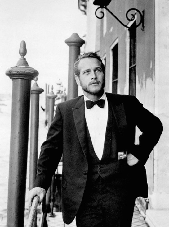 Photographed in Venice in 1963, Paul Newman's slim, restrained three piece dinner suit embodies early 1960s minimalism.