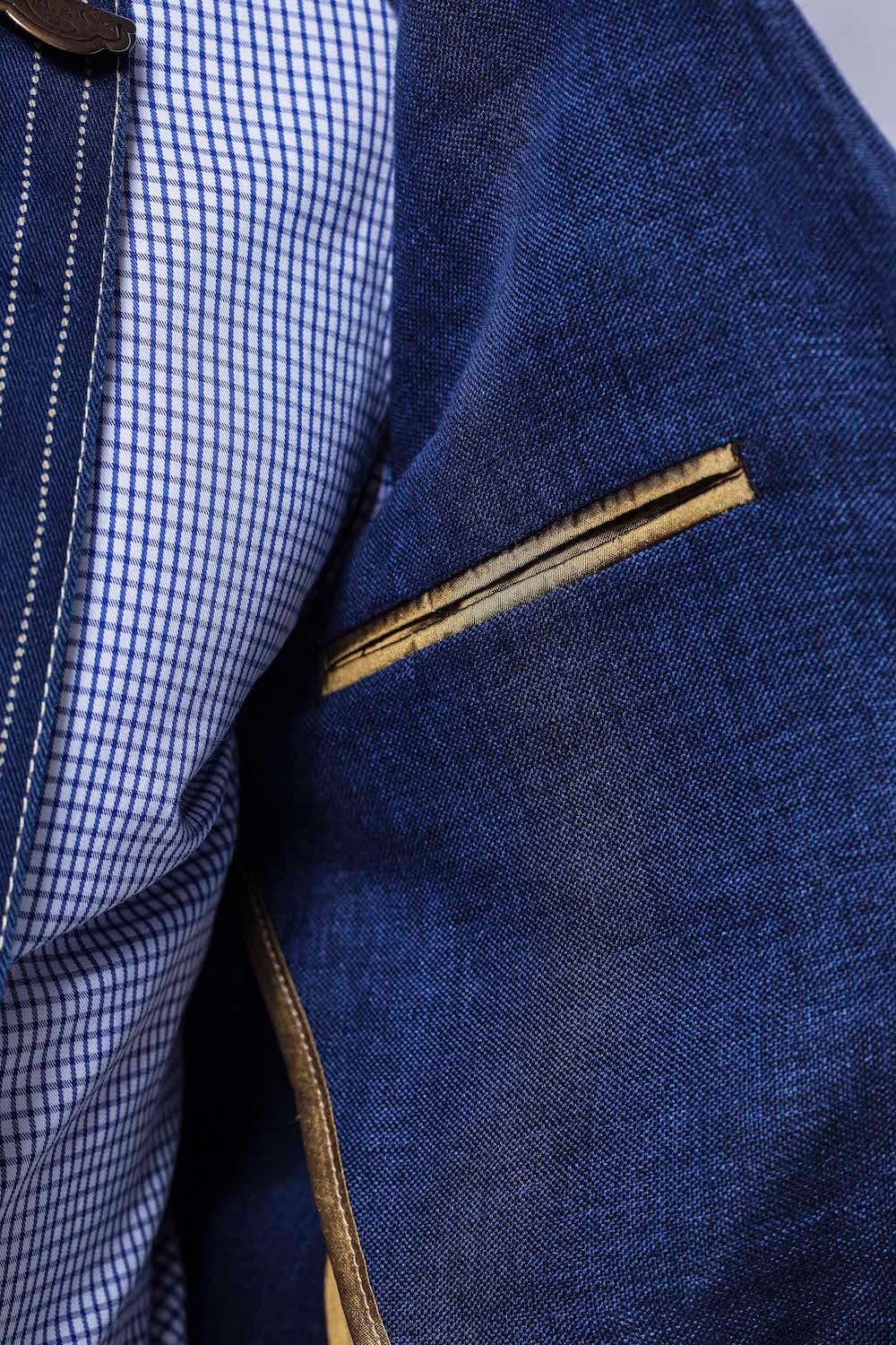 Note that the jacket's internal breast pockets are lined in The Rake's signature gold piping.