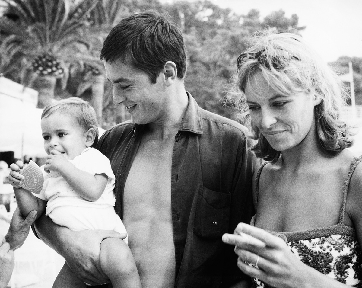 French actor Alain Delon with his wife Nathalie and their son Anthony on the beach at Monte Carlo, 15th August 1965.