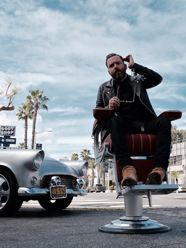 Mark Holmes reclines in style, with Pankhurst's trademark Bentley-upholstered barber chair.