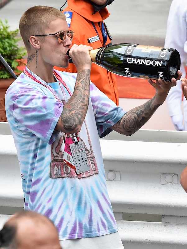 MONTE-CARLO, MONACO - MAY 29:  Justin Justin Bieber drinks champagne from the bottle of F1 Grand Prix of Monaco winner, Lewis Hamilton at the 2016 race. Photo by Pascal Le Segretain/Getty Images.
