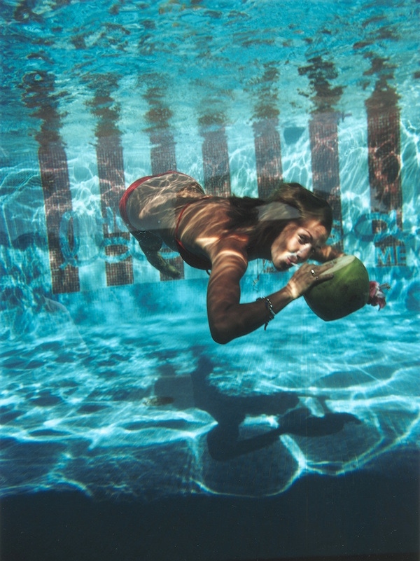 A woman drinking from a coconut underwater in the pool at Las Brisas Hotel in Acapulco, Mexico, February 1972 (Photograph by Slim Aarons)