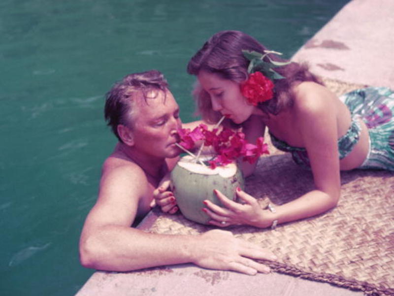 Teddy Stauffer and a friend share a drink from a coconut shell, Acapulco, Mexico, 1952 (Photoraph by Slim Aarons)