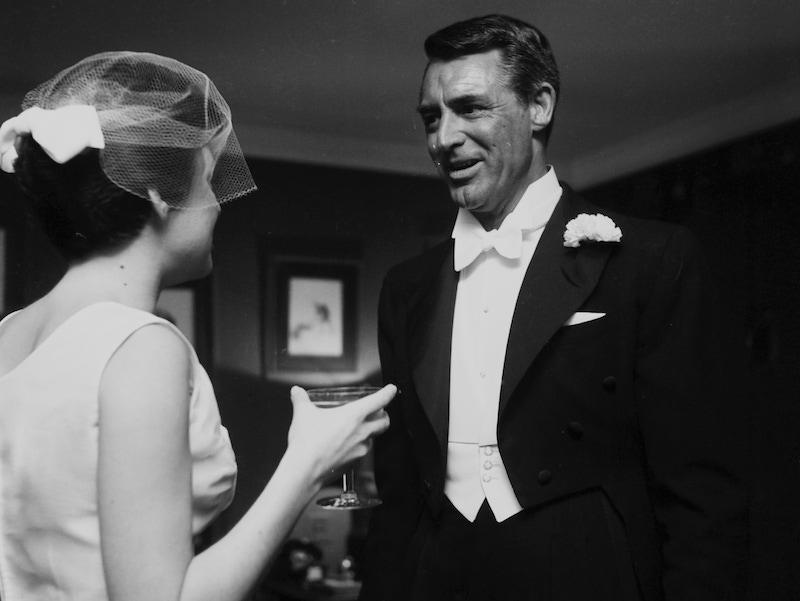 Cary Grant with Barbara Rodney at a wedding in Los Angeles, 1955. Photo by Earl Leaf/Michael Ochs Archives/Getty Images.