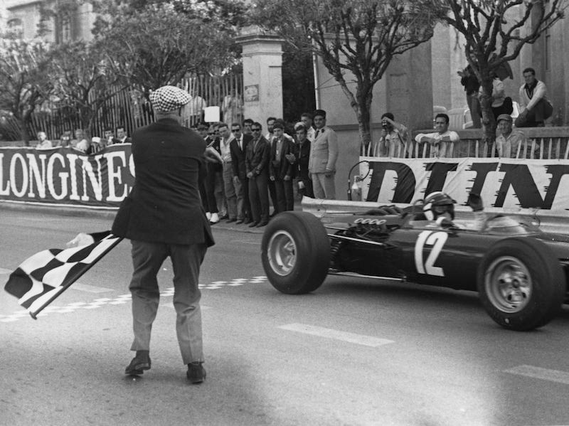 Jackie Stewart taking the checkered flag to win the 1966 Monaco Grand Prix. (Photo by Victor Blackman/Daily Express/Hulton Archive/Getty Images)