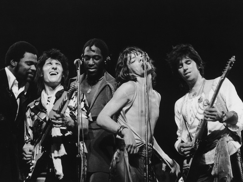 Left to right: Keyboard player Billy Preston, Giuitarist Ron Wood, percussionist Ollie Brown, singer Mick Jagger and guitarist Keith Richards, 1976. Photo by Graham Wood/Evening Standard/Hulton Archive/Getty Images.