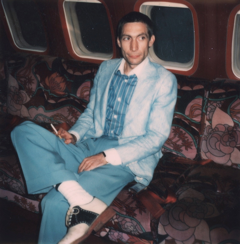 Circa 1975: Polaroid image of Charlie Watts, drummer with The Rolling Stones posed on an aeroplane circa 1975. Photo by Mark and Colleen Hayward/Redferns.