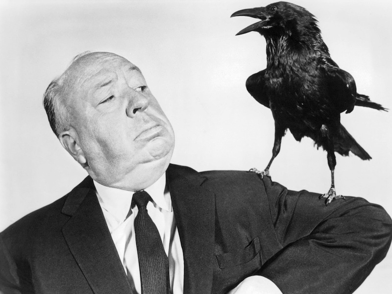 Alfred Hitchcock poses with a stuffed crow in a promotional portrait for his film 'The Birds', 1963. Photo by Silver Screen Collection/Getty Images.