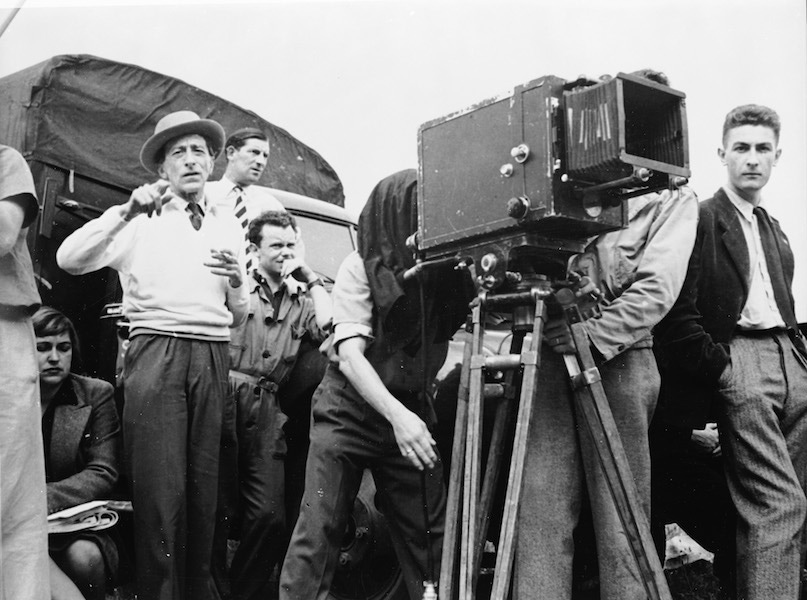 Jean Cocteau directs a scene from his film 'La Belle et la Bete' (aka 'Beauty and the Beast) while members of his crew watch, France, 1946. Photo by Hulton Archive/Getty Images.