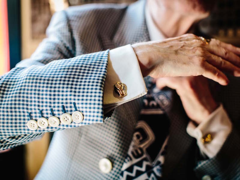 George wears a beautiful antique tie pin. “It’s a sunflower, which is an Egyptian symbol for their god, Amun-Ra. I got the cufflinks from the British Museum, where I used to work in the rare books department.” George’s passion for trinkets and treasures is at one with his eye for detail. “I go over every now and then, and usually I walk straight past the shop but these just stood out – they’re gold plated and I love history. I don’t know what it is, but I go a bit bonkers for it.”