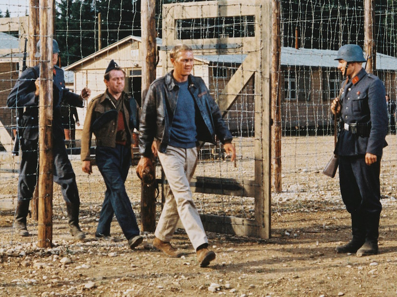 McQueen being marched through a gate by German guards in a publicity still issued for the film, 'The Great Escape', 1963. Photo by Silver Screen Collection/Getty Images.