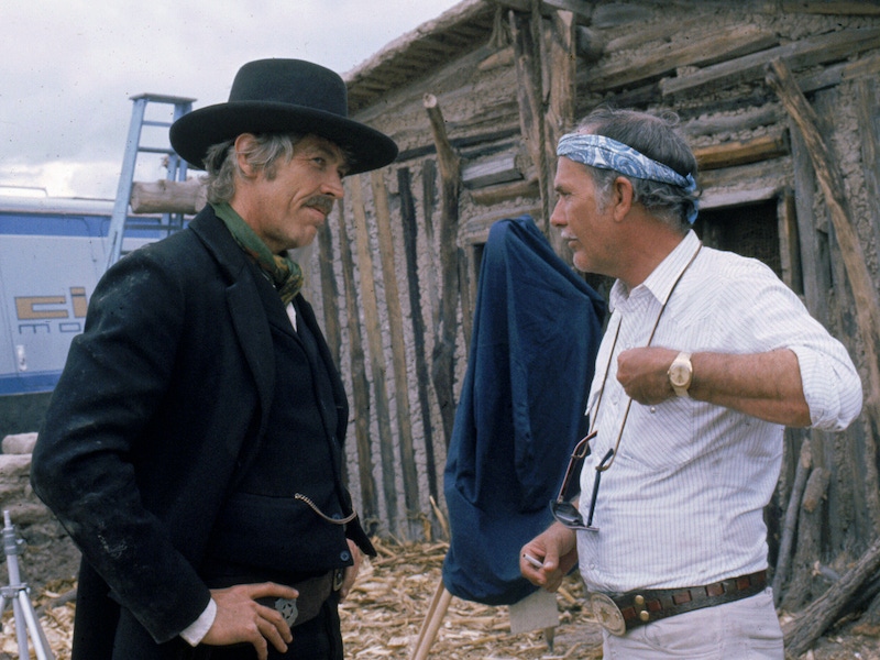 James Coburn in costume and Sam Peckinpah on the set of the film, 'Pat Garrett and Billy the Kid', USA, 1973. Photo by Silver Screen Collection/Getty Images.