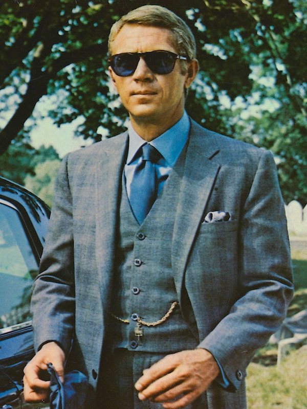 Steve McQueen wearing sunglasses with a grey suit, a blue shirt and dark blue tie in a publicity image issued for the film, 'The Thomas Crown Affair', 1968. (Photo by Silver Screen Collection/Getty Images)