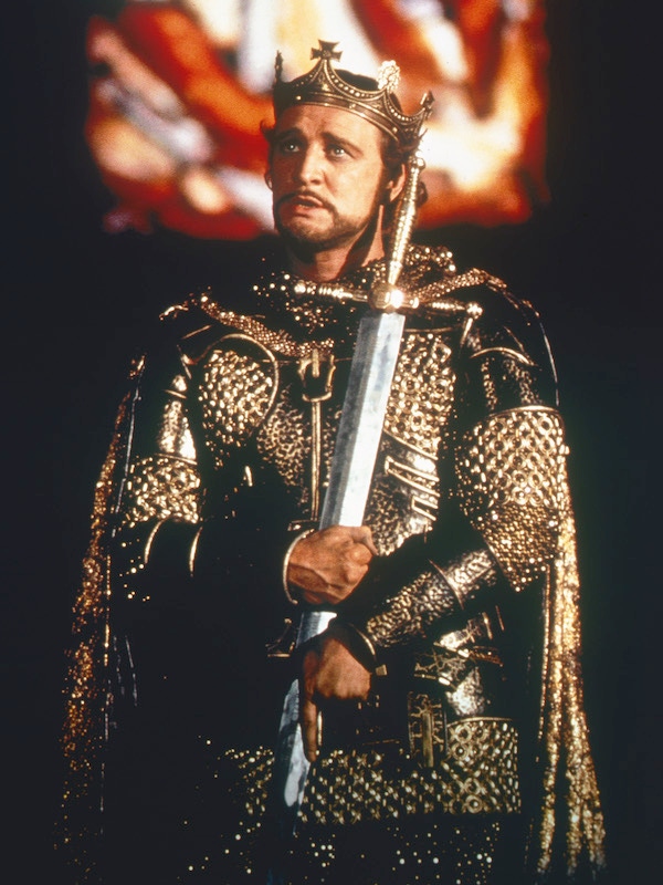 Richard Harris wearing a crown and an ornate suit of armour, holding a sword to his chest, in a publicity still issued for the film, 'Camelot', 1967. The musical starred Harris as 'King Arthur'. Photo by Silver Screen Collection/Getty Images.