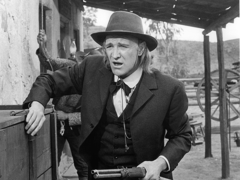 Richard Harris holds a gun in a scene from the film 'The Deadly Trackers', 1973. Photo by Warner Brothers/Getty Images.