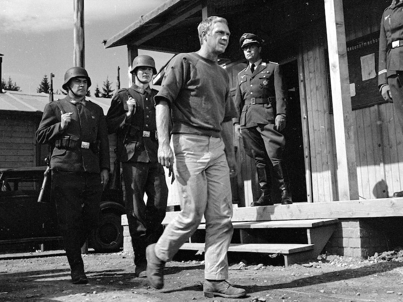 Steve McQueen as Captain Virgil Hilts and Robert Freitag, as Hauptmann Posen, in 'The Great Escape', directed by John Sturges, 1963. Photo by Silver Screen Collection/Getty Images.