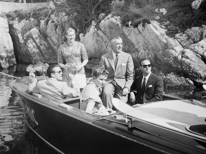 Actress Ingrid Bergman with Cannes Film Festival director general Robert Favre Le Bret and directors Vittorio De Sica and Roberto Rossellini during speedboat tour to the Lerins Islands in the bay of Cannes in May 1956 in Cannes, France.