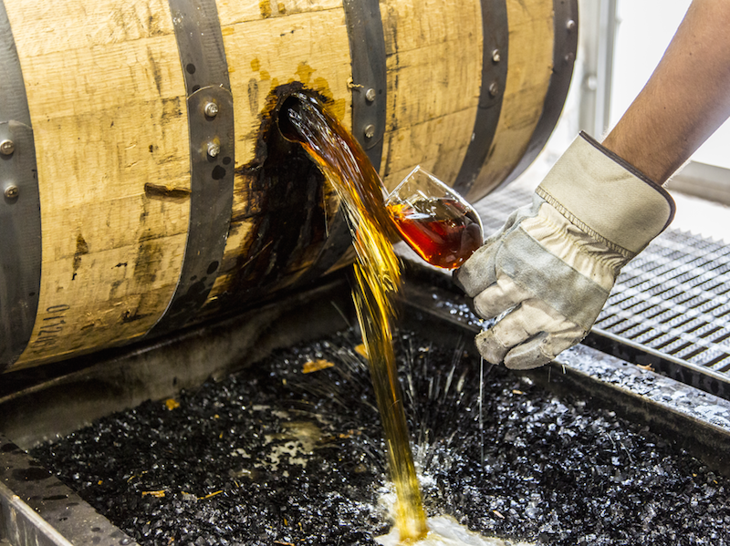 A Woodford Reserve worker samples one of their barrels, ready for bottling. (Images courtesy of Woodford Reserve)