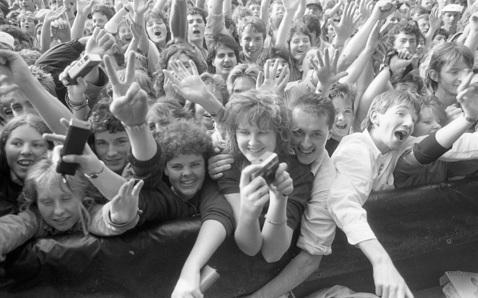 Fans dancing at the Bruce 'The Boss' Springsteen concert as part of his 'Tunnel Of Love' World Tour at the R.D.S, 1988. Photo by Independent News And Media/Getty Images.