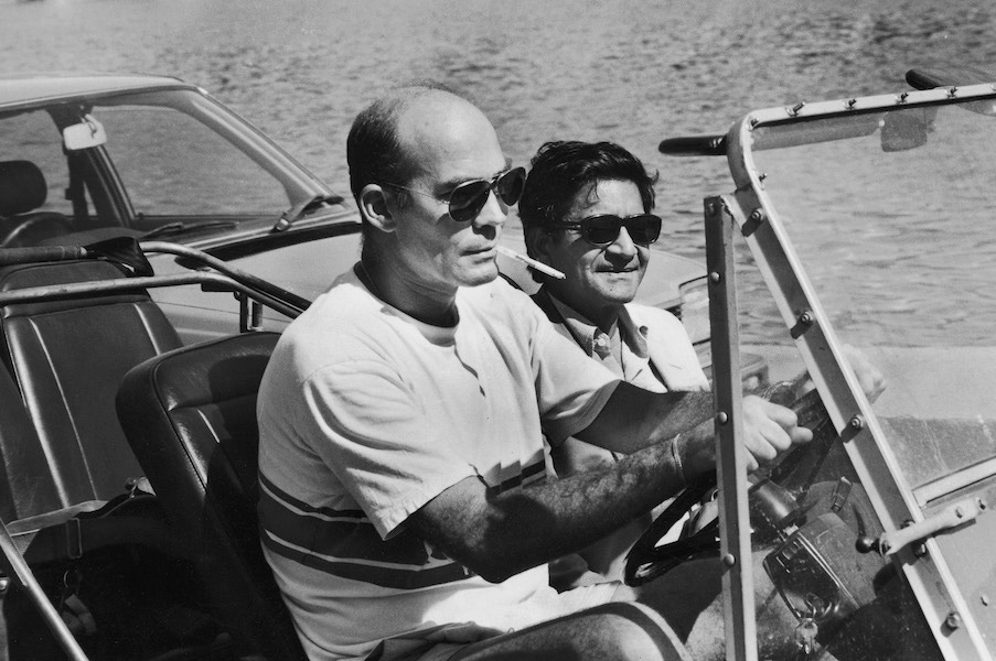 Hunter S. Thompson and writer V.S. Naipaul riding in mini moke reporting on Grenada after US involvement. Photo by Matthew Naythons/The LIFE Images Collection/Getty Images.