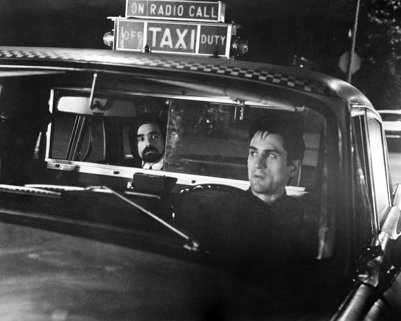 Director Martin Scorsese (left) as the 'Silhouette Watching Passenger', and Robert De Niro as Travis Bickle in 'Taxi Driver', directed by Scorsese, 1976. Photo by Silver Screen Collection/Getty Images.