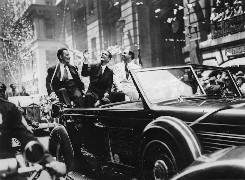 The flight pilot Howard Hughes (centre) is congratulated after his record flight around the world in New York. July 1938. Photograph. Photo by Austrian Archives/Imagno/Getty Images.