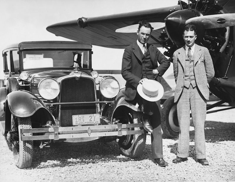 =Howard Hughes and stunt flyer Roscoe Turner at an airport in California. Hughes is driving the official car of the Pacific Aero Club, 1928. Photo by Underwood Archives/UIG/REX/Shutterstock.