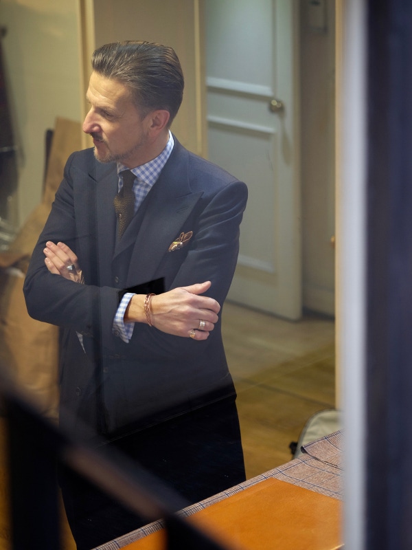 Clive’s suit is the realisation of a long-held ambition, to own a suit cut in Chittleborough & Morgan’s signature style; with broad peaked lapels, strong shoulders, a heavily structured svelte coat, waistcoat and high-waisted forward-pleated trousers. Cut in trusty Dugdale Bros & Co navy cavalry twill, a favourite cloth of Joe Morgan’s, the suit was Clive’s fiftieth birthday present to himself. “When it came to my fiftieth, I decided that I was going to go to Savile Row and get something made. When I started to think about where it was going to be from, it was always going to be Chittleborough & Morgan.”