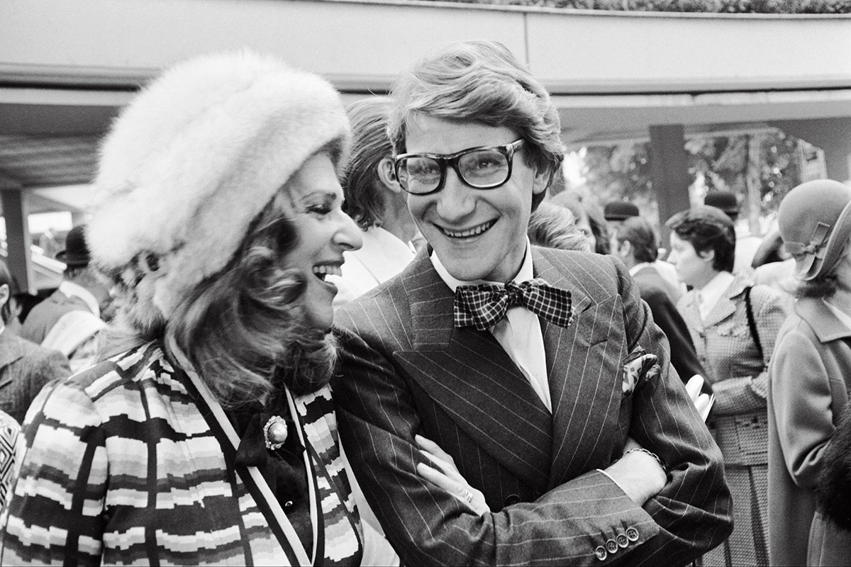 Baroness Rothschild laughing with Yves Saint Laurent at the Longchamp racecourse, 1973 (Photo via Getty)