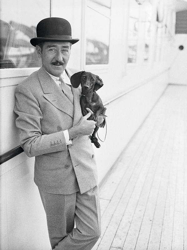 Holding a Dachshund aboard a ship, 1932