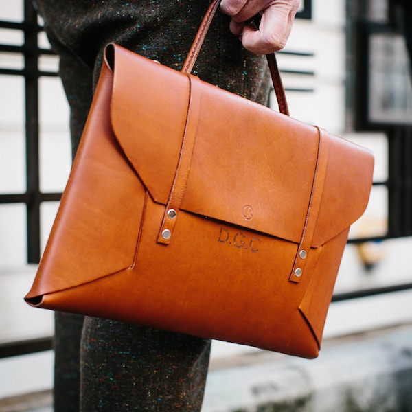 Dean’s bag is a reinterpretation of his school music bag from when he was a child – which his friend, ex-colleague and craftsman Jade Rhone made for him. “I kept the bar from the original bag so it’s a bit rusty, and it’s just one piece of leather that folds into itself and which has my initials and my friend’s logo.” He keeps his iPad, and other necessities in it and he adds, “I need one to go with every outfit!”