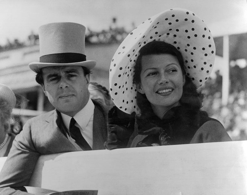 Prince Aly Khan at Epsom races with his wife, Hollywood actress Rita Hayworth. Photo by George W Hales/Getty Images.