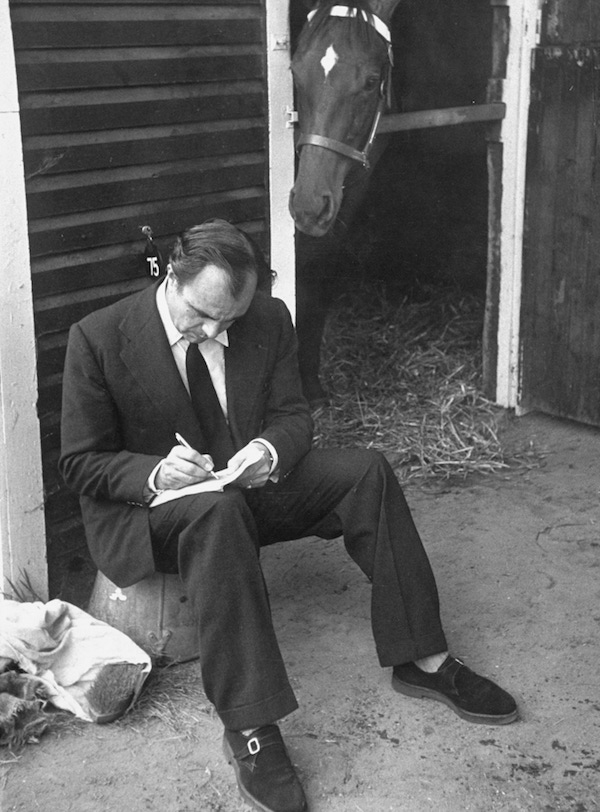 Prince Aly Khan writing on piece of paper before horse auction. (Photo by Ralph Morse/The LIFE Picture Collection/Getty Images)