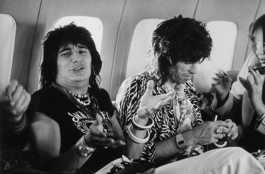 Guitarists Ron Wood (left) and Keith Richards in the Rolling Stones' private jet during the group's 1975 Tour of the Americas. Photo by Christopher Simon Sykes/Hulton Archive/Getty Images.