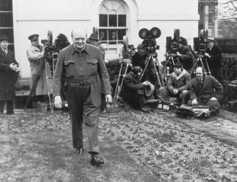 British Prime Minister Winston Churchill poses for the cameras in the grounds of the White House, wearing his 'siren suit', a one-piece garment which can be donned in a minute, 17th January 1942. Photo by Hulton Archive/Getty Images.