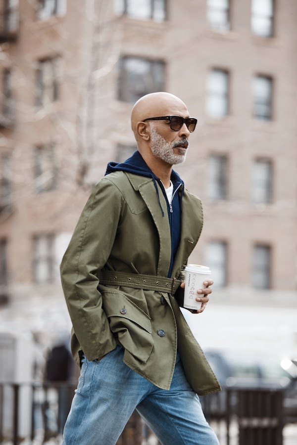 Laundered green Grenfell cloth cotton Shooter jacket, Grenfell for The Rake; navy cotton Guernsey knit, zip front hooded jumper, Orlebar Brown; white linen T-shirt, Timothy Everest; camouflage acetate Lord sunglasses with a gradient lens, Oliver Goldsmith for The Rake.