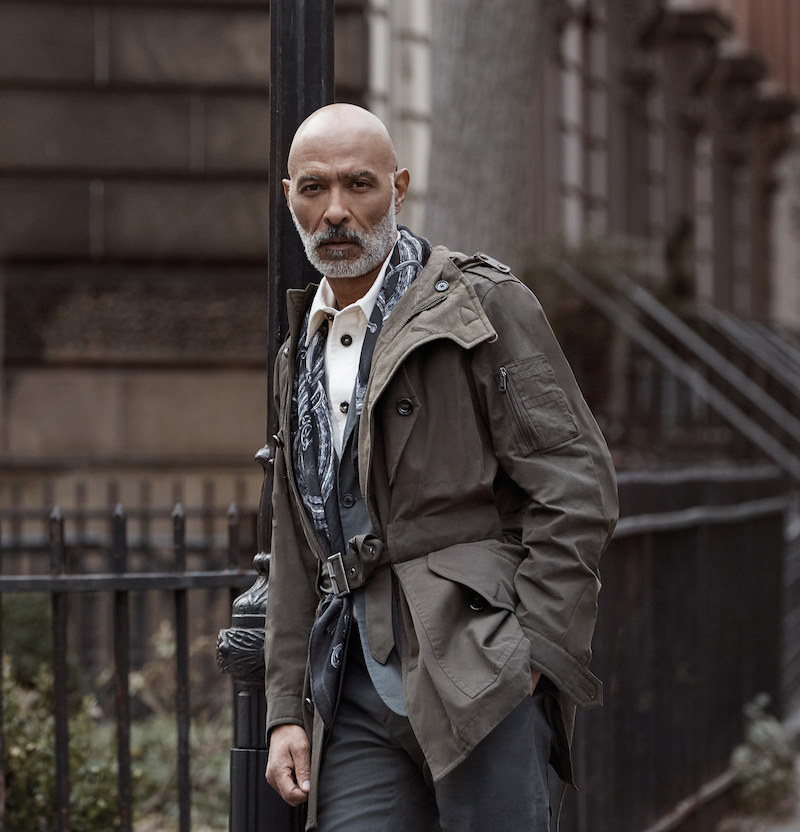 Olive green cotton safari jacket,  Ralph Lauren Purple Label; khaki green cotton two-piece suit and cornflower blue floral print cashmere scarf, both Hermès; ecru cotton  safari shirt, Private White V.C.