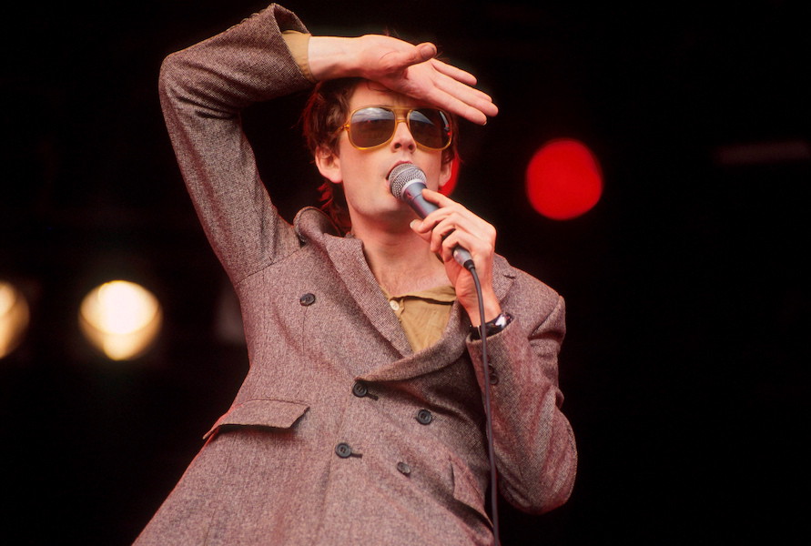 Jarvis Cocker of Pulp performs on stage at Glastonbury Festival, June 1994. Photo by Michael Putland/Getty Images.